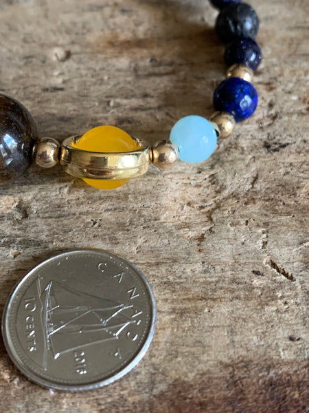 Bracelet ajustable espace et étoiles billes de verre Comme un ange