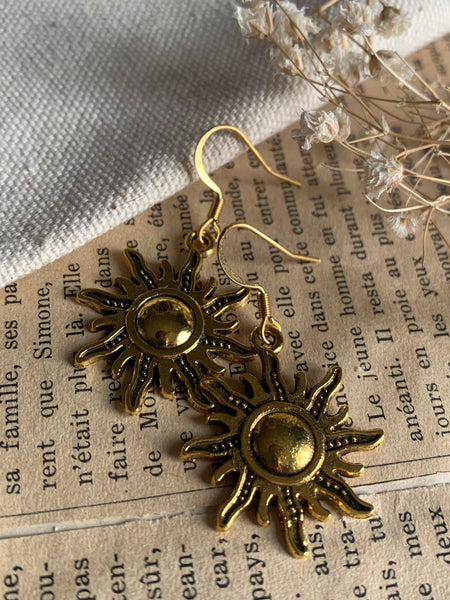 Boucles d’oreilles breloque soleil or alliage de métaux Comme un ange